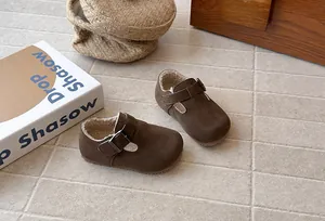 Vintage children's brown suede loafers featuring warm fleece lining and buckle strap