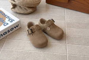 Detail of retro kids' suede buckle shoes with warm fleece lining and soft sole