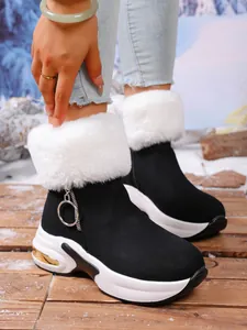 Women's hidden wedge snow boots with white faux fur collar and platform sole detail