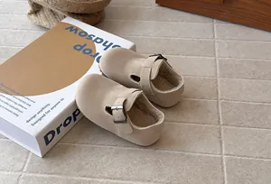 Close-up of kids retro fleece-lined buckle shoes in beige with soft cozy faux fur lining