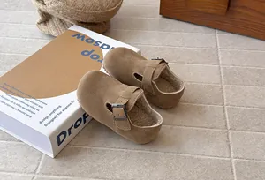 Close-up of vintage brown children's Birkenstock shoes with cozy fleece lining and buckle.
