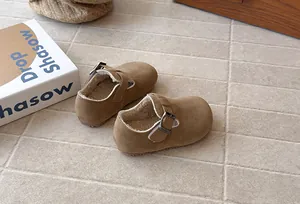 Detail view of children's vintage brown suede loafers featuring warm white fleece lining