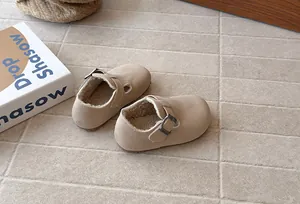 Close-up of beige fleece-lined children's shoes with adjustable buckle detail