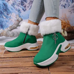 Green platform snow boots for women with white faux fur lining and side zipper details.