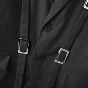 Primo piano di fibbie metalliche argentate decorative su un blazer nero slim da uomo