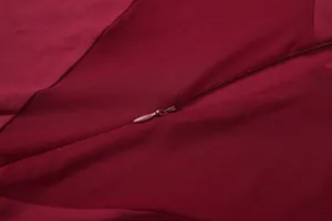 Primer plano de la cremallera invisible y detalle de malla sexy en este body burdeos