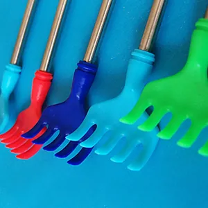 Macro view of colorful plastic claw heads on retractable stainless steel back scratchers