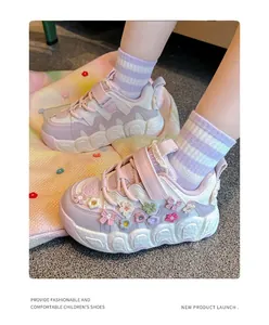 Detailed view of pink girls' floral sneakers featuring soft soles and hook-loop straps