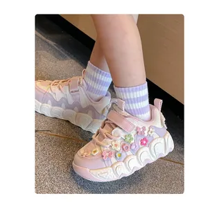 Detail shot of girls' lavender chunky sneakers featuring 3D floral accents and soft soles.