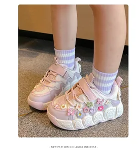 Close-up of girls' pink floral sports sneakers with soft soles and Velcro straps