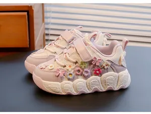 Close-up of pink girls' sneakers featuring colorful 3D knitted floral decorations