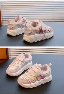 Detailed view of girls' pastel sneakers featuring 3D floral embroidery and velcro straps