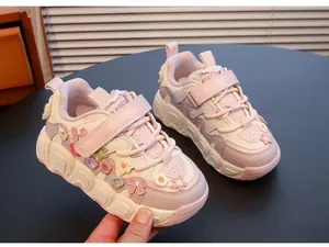 Detailed view of girls pink sneakers with 3D floral accents and wavy soft soles