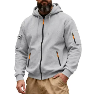 Detail of men's gray heavyweight zip-up hoodie with orange zipper accents and cargo pocket.