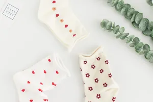 Detail showing various heart and flower patterns on soft cotton crew socks for girls
