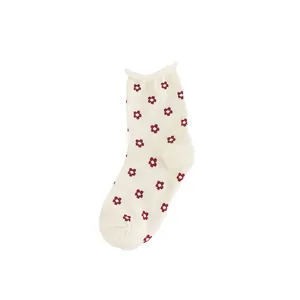 Cream-colored mid-calf cotton socks with red flower print and ruffled top edge.