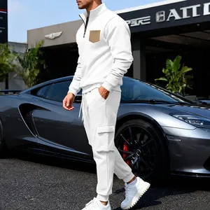 Athletic men's white two-piece tracksuit with quarter-zip sweatshirt and cargo sweatpants.