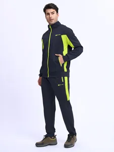 Detail of men's navy athletic tracksuit featuring lime green accents and zip pockets