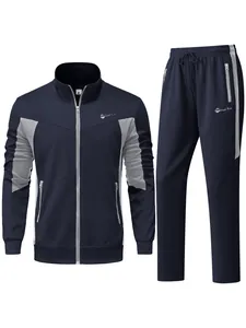 Two-piece men's navy blue tracksuit with grey color block design and zip pockets