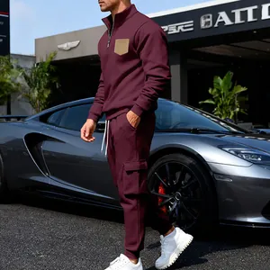 Men's burgundy fleece tracksuit set with quarter-zip top and cargo sweatpants in urban setting