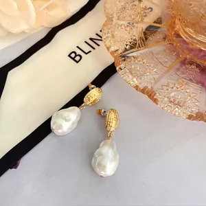 Eleganti orecchini di perle barocche con perni dorati e chiusura in argento 925 da donna.