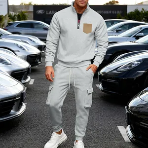Grey men's fleece tracksuit set with stand collar sweatshirt and cargo joggers.