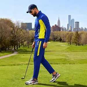 Men's blue and yellow color-block athletic tracksuit two-piece set worn on a scenic golf course