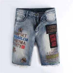 Trendy slim fit men's light blue denim shorts with bee embroidery and raw fringe hem