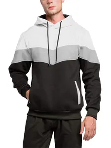 Close-up detail of a modern color-block hoodie featuring white, grey and black panels