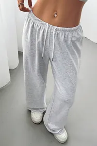 Detail view of light grey wide-leg lounge pants showing drawstring and fabric texture