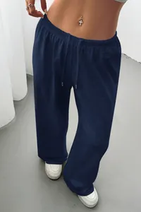 Detail of navy blue wide-leg lounge pants on model with drawstring waist