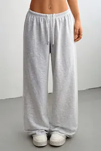 Close-up of grey wide-leg lounge sweatpants featuring an adjustable drawstring waist