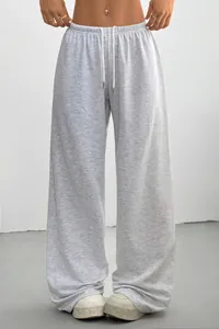 Detail view of grey wide-leg sweatpants with drawstring waist