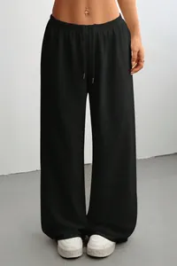 Detail view of comfortable black high-waisted wide-leg sweatpants with drawstring waist