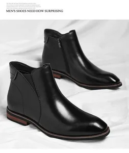 Close-up detail of black leather men's zip boots on white fabric