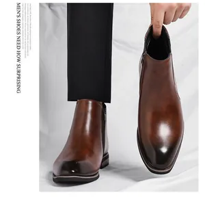 Detailed view of men's brown leather Chelsea boots with side zipper and gradient toe