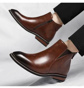 Detailed view of men's brown Chelsea boots with side zipper and vintage finish