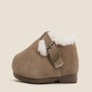 Detailed view of brown suede baby shoes with warm white fleece lining and buckle.