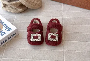 Detailaufnahme von roten Sherpa-Prinzessinnenschuhen für Babys mit Strass-Schnalle