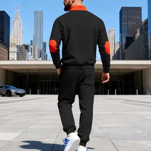 Back view of men's black heavy fleece tracksuit with orange elbow patches detail
