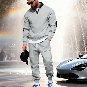 Detail showing the heavy fleece texture and cargo pocket design of the grey tracksuit.