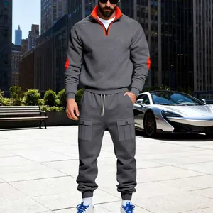 Men's grey heavyweight fleece tracksuit with orange trim in urban outdoor setting