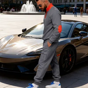 Detailed view of men's gray heavyweight fleece tracksuit with orange stand collar accents.