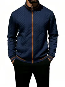 Close-up detail of navy blue quilted men's zip-up jacket with contrast tan trim and collar