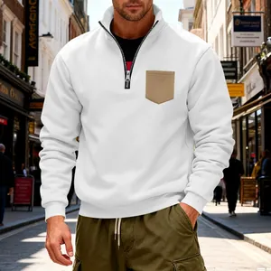 Detailed close-up of a white quarter-zip fleece sweatshirt with a khaki chest pocket