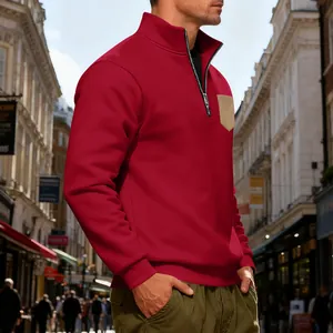 Detail view of men's red quarter-zip sweatshirt with a contrasting tan chest pocket