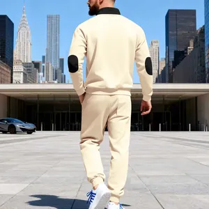 Back view of men's cream relaxed tracksuit with black elbow patches and stand collar