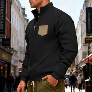 Close-up detail of men's black heavy fleece half-zip sweatshirt with khaki chest pocket
