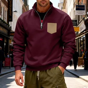 Detailed shot of men's burgundy heavy fleece sweatshirt with khaki pocket and half-zip