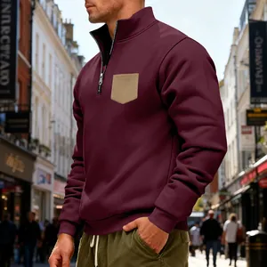Detail view of men's burgundy heavy fleece sweatshirt with quarter-zip and khaki pocket.